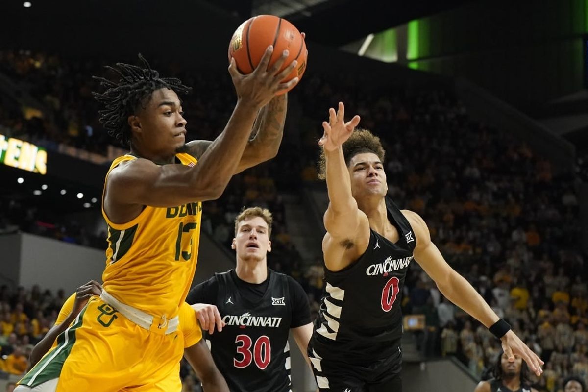 Jan 13, 2024; Waco, Texas, USA; Baylor Bears guard Langston Love (13) grabs the rebound in front of Cincinnati Bearcats guard Dan Skillings Jr. (0) during the first half at Paul and Alejandra Foster Pavilion.