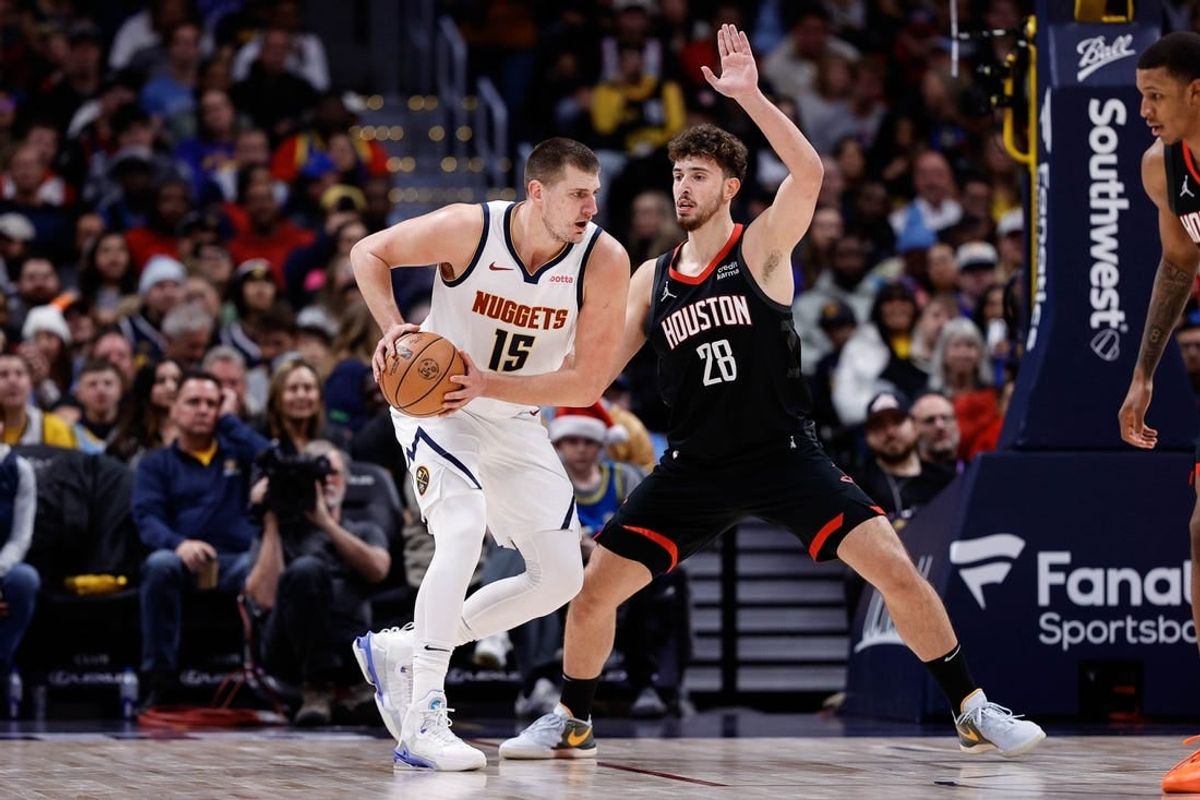 Nov 29, 2023; Denver, Colorado, USA; Denver Nuggets center Nikola Jokic (15) controls the ball as Houston Rockets center Alperen Sengun (28) guards in the second quarter at Ball Arena.