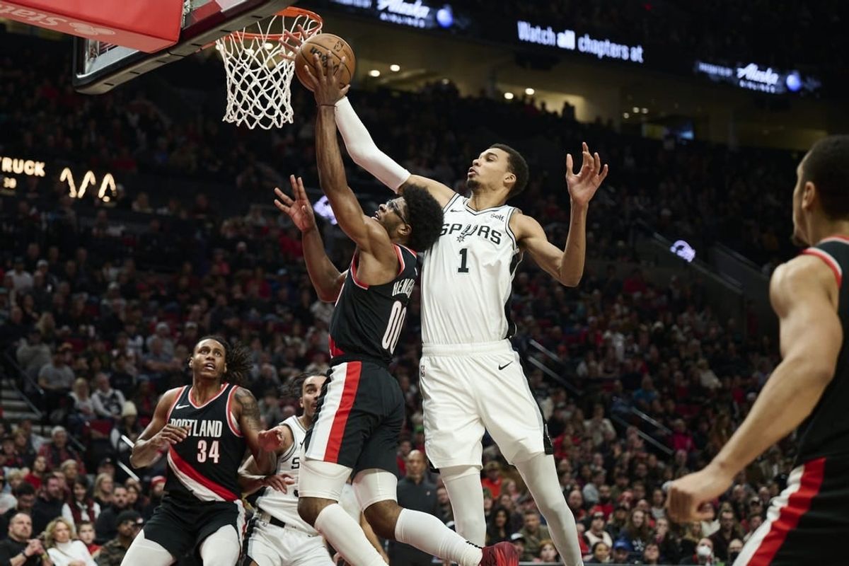 Dec 28, 2023; Portland, Oregon, USA; San Antonio Spurs center Victor Wembanyama (1) blocks a shot during the first half against Portland Trail Blazers guard Scoot Henderson (00) at Moda Center.