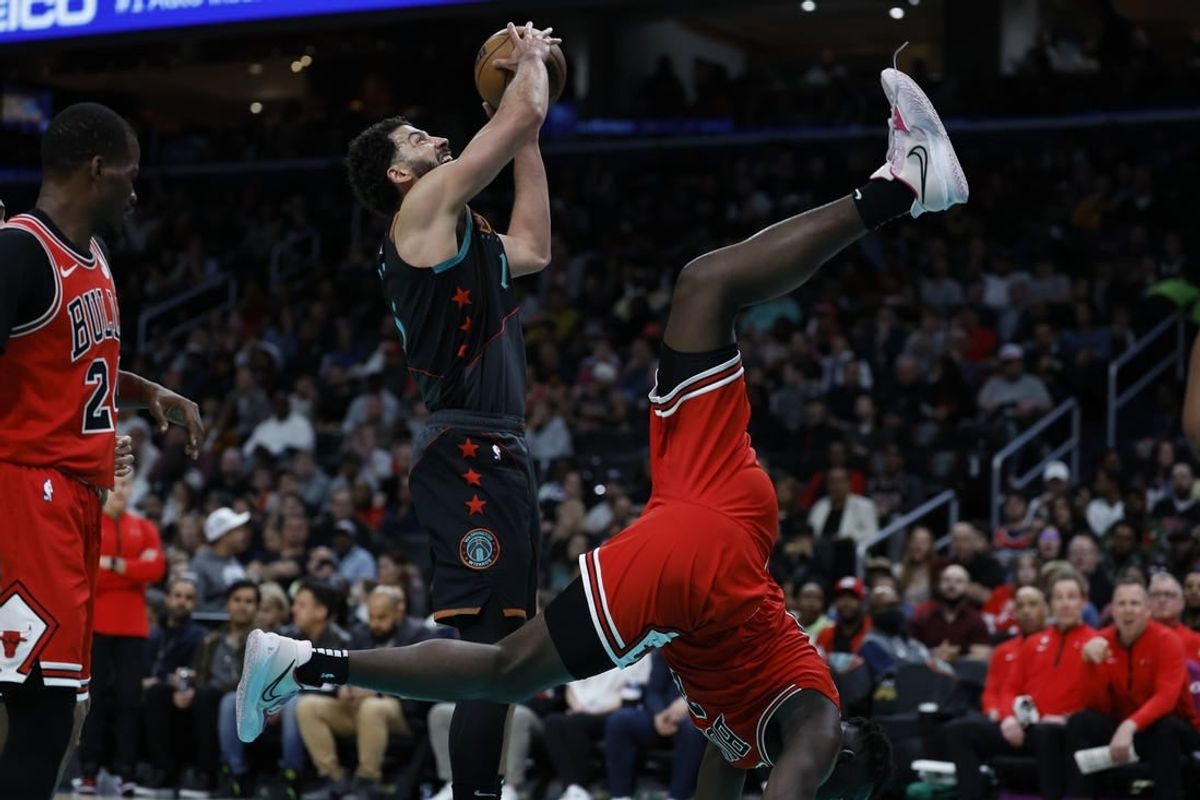 Apr 12, 2024; Washington, District of Columbia, USA; Chicago Bulls center Adama Sanogo (21) flips over Washington Wizards forward Anthony Gill (16) while defending a shit attempt in the first half at Capital One Arena.