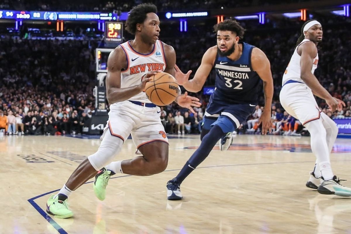 Jan 1, 2024; New York, New York, USA;  New York Knicks forward OG Anunoby (8) looks to drive past Minnesota Timberwolves center Karl-Anthony Towns (32) in the fourth quarter at Madison Square Garden.