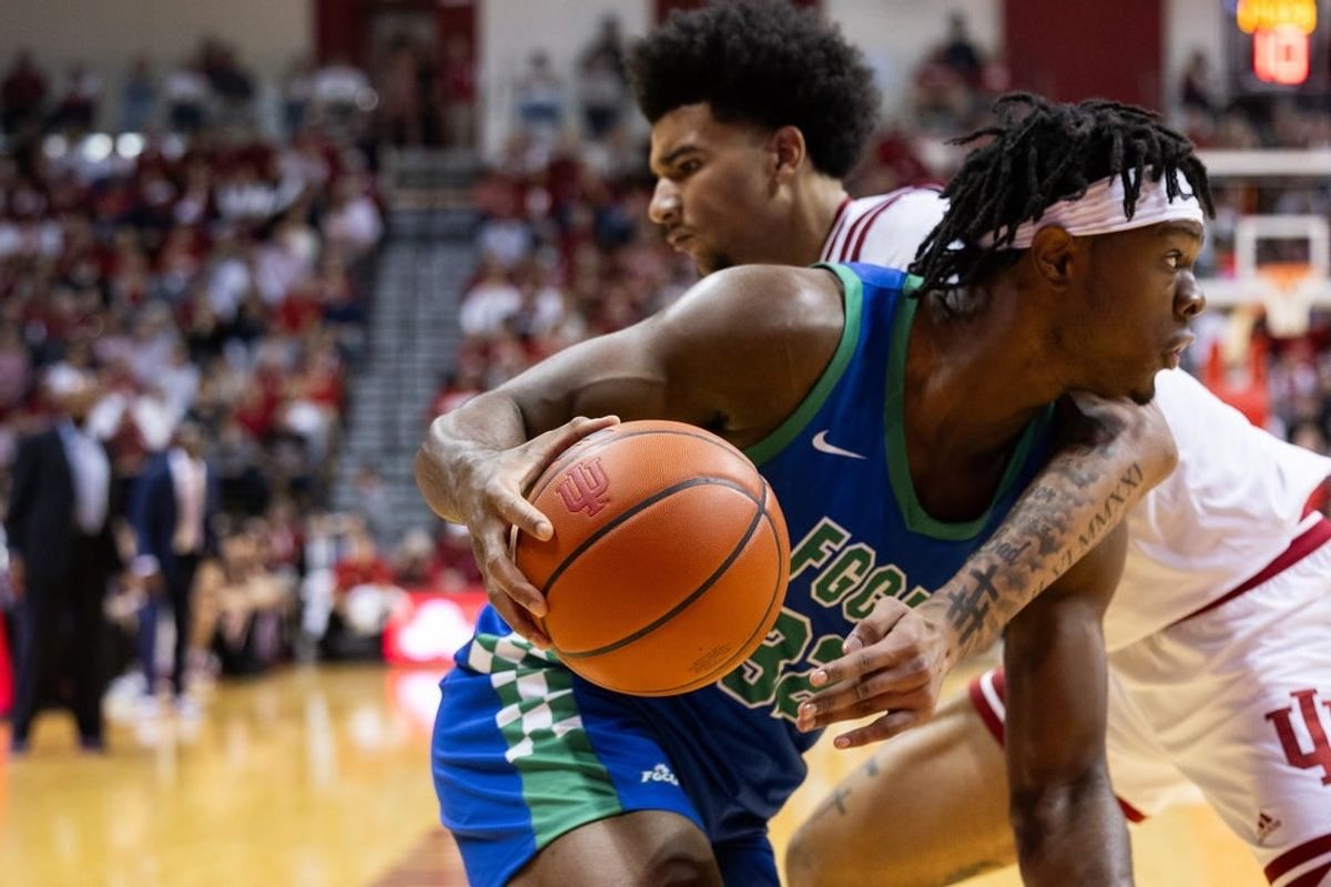 Nov 7, 2023; Bloomington, Indiana, USA; Florida Gulf Coast Eagles forward Keeshawn Kellman (32) dribbles against Indiana Hoosiers center Kel'el Ware (1) in the second half at Simon Skjodt Assembly Hall.