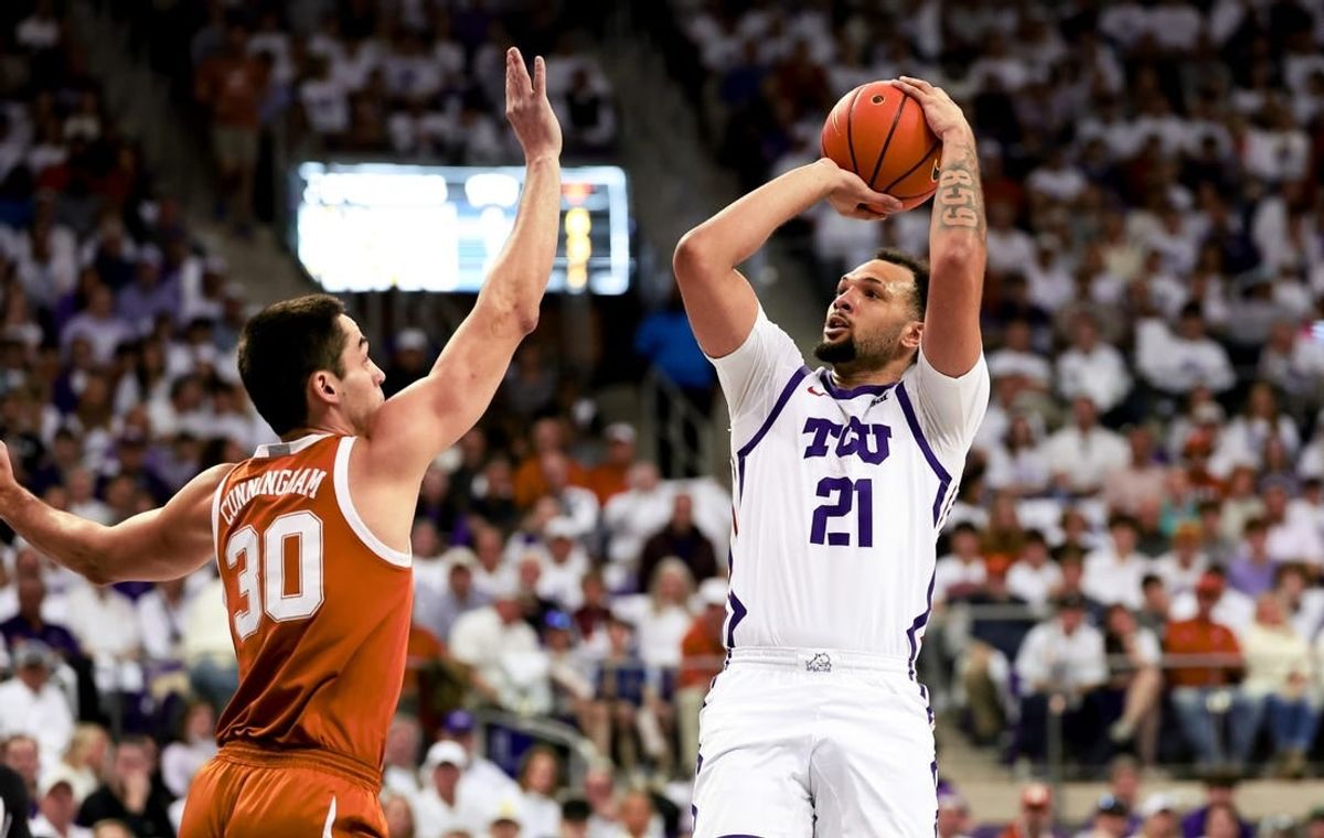 Feb 3, 2024; Fort Worth, Texas, USA;  TCU Horned Frogs forward JaKobe Coles (21) shoots over Texas Longhorns forward Brock Cunningham (30) during the first half at Ed and Rae Schollmaier Arena.