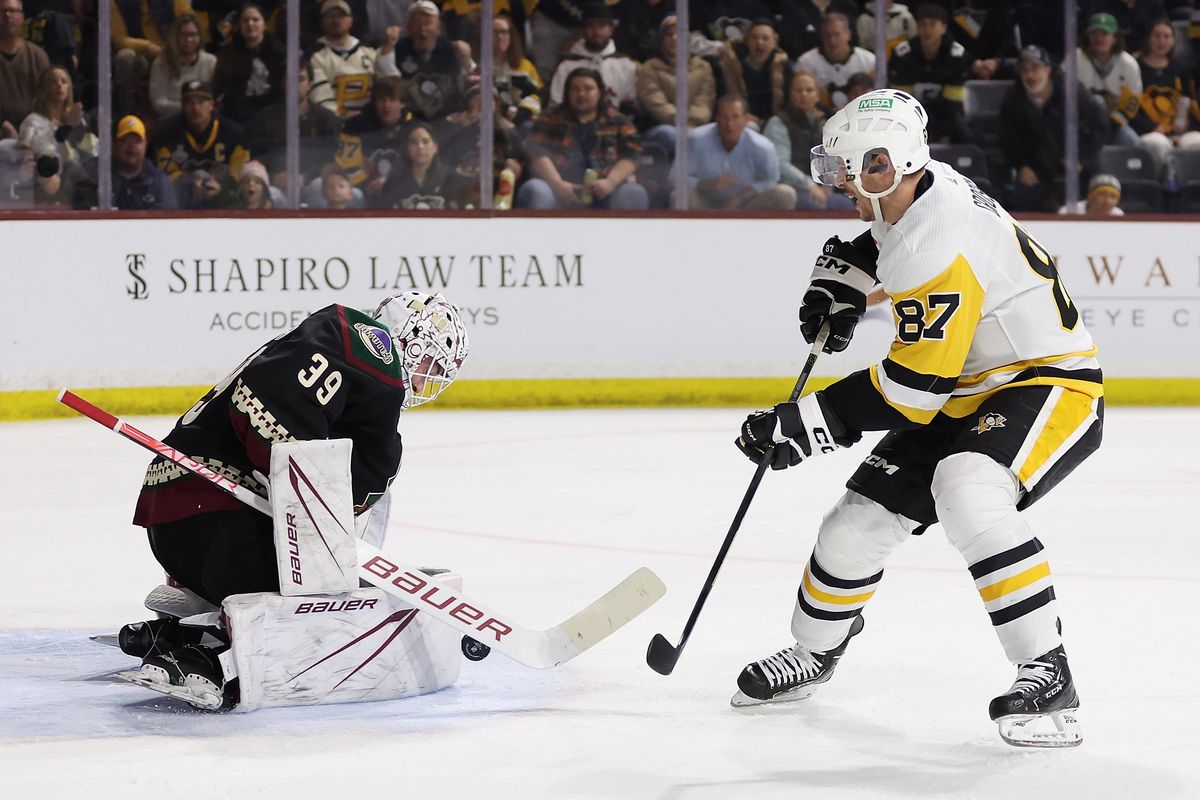 TEMPE, ARIZONA - JANUARY 22: Sidney Crosby #87 of the Pittsburgh Penguins attempts a shot on goaltender Connor Ingram #39 of the Arizona Coyotes during the first period of the NHL game at Mullett Arena on January 22, 2024 in Tempe, Arizona. (Photo by Christian Petersen/Getty Images)