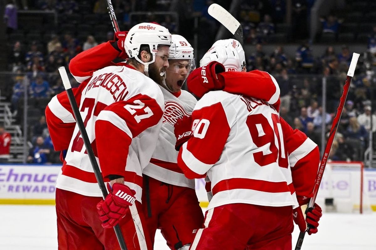 Dec 12, 2023; St. Louis, Missouri, USA;  Detroit Red Wings center Michael Rasmussen (27) is congratulated by defenseman Moritz Seider (53) and center Joe Veleno (90) after scoring against the St. Louis Blues during the third period at Enterprise Center.