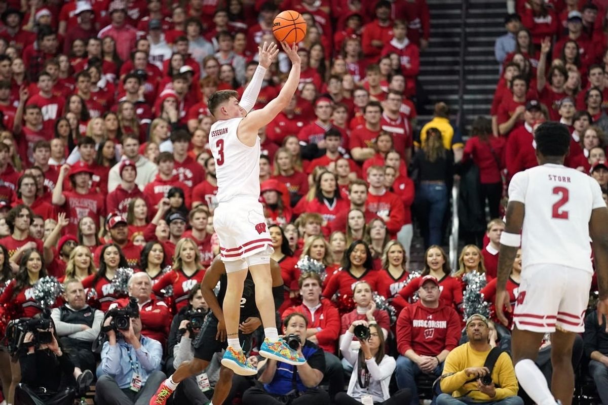 Jan 26, 2024; Madison, Wisconsin, USA; Wisconsin Badgers guard Connor Essegian (3) scores a three point basket against the Michigan State Spartans during the first half at the Kohl Center.
