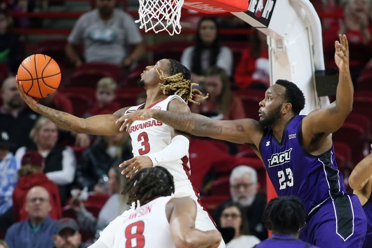 Dec 21, 2023; Fayetteville, Arkansas, USA; Arkansas Razorbacks guard El Ellis (3) shoots as Abilene Christian Wildcats forward Airion Simmons (23) defends during the first half at Bud Walton Arena.