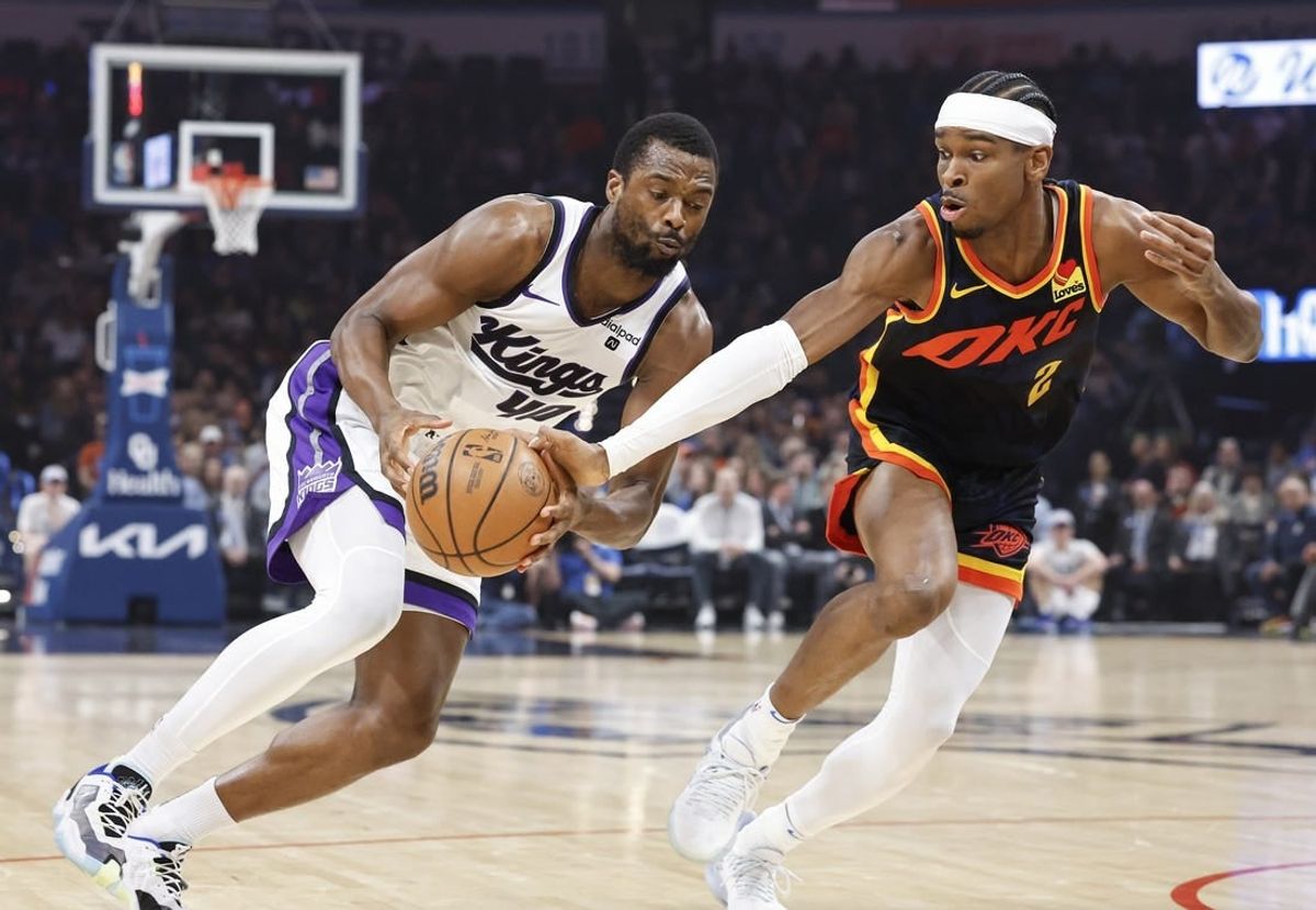 Feb 11, 2024; Oklahoma City, Oklahoma, USA; Oklahoma City Thunder guard Shai Gilgeous-Alexander (2) reaches to steal the ball from Sacramento Kings forward Harrison Barnes (40) during the first quarter at Paycom Center.