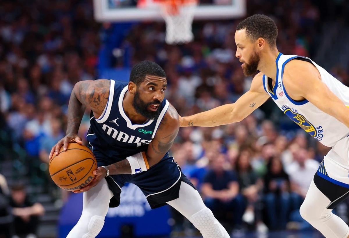 Apr 5, 2024; Dallas, Texas, USA;  Dallas Mavericks guard Kyrie Irving (11) looks to score as Golden State Warriors guard Stephen Curry (30) defends during the first half at American Airlines Center.
