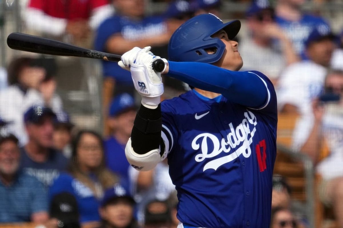 Feb 27, 2024; Phoenix, Arizona, USA; Los Angeles Dodgers designated hitter Shohei Ohtani (17) hits a two run home run during the fifth inning against the Chicago White Sox at Camelback Ranch-Glendale.