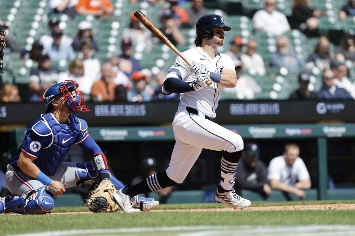Apr 16, 2024; Detroit, Michigan, USA;  Detroit Tigers third baseman Zach McKinstry (39) hits an RBI triple in the third inning against the Texas Rangers at Comerica Park.