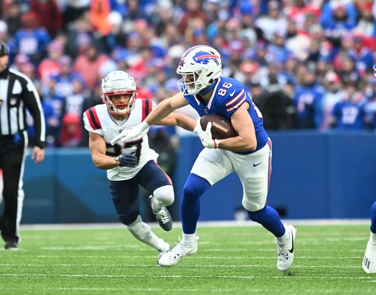 Dec 31, 2023; Orchard Park, New York, USA; Buffalo Bills tight end Dalton Kincaid (86) turns up field after a catch in front of New England Patriots safety Kyle Dugger (23) in the first quarter at Highmark Stadium.
