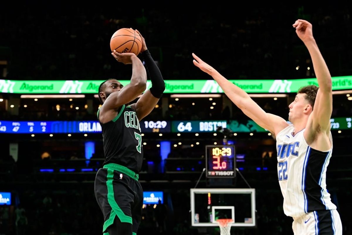 Dec 15, 2023; Boston, Massachusetts, USA; Boston Celtics guard Jaylen Brown (7) shoots the ball over Orlando Magic forward Franz Wagner (22) during the second half at TD Garden.
