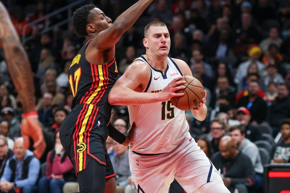 Dec 11, 2023; Atlanta, Georgia, USA; Denver Nuggets center Nikola Jokic (15) drives past Atlanta Hawks forward Onyeka Okongwu (17) in the first quarter at State Farm Arena.