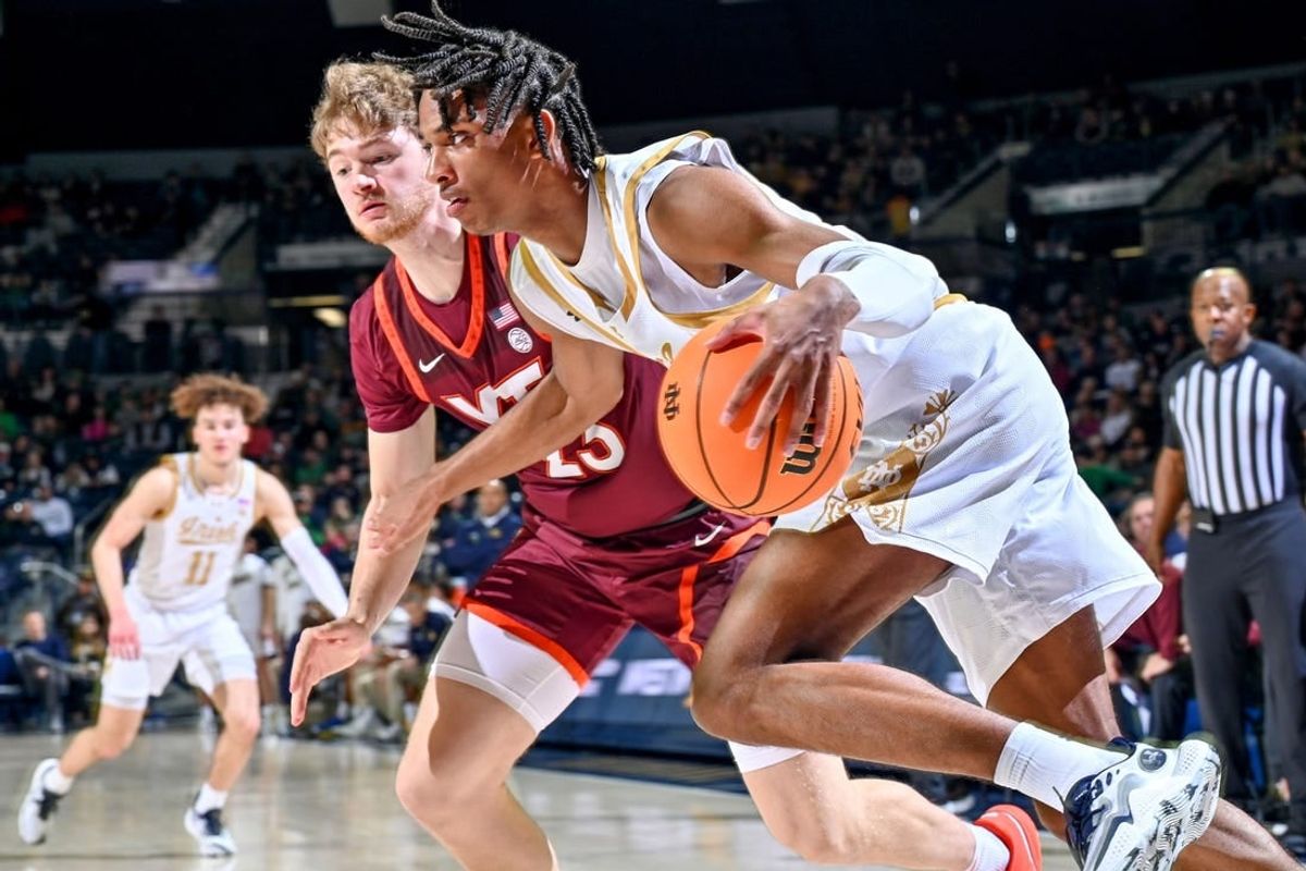 Feb 10, 2024; South Bend, Indiana, USA; Notre Dame Fighting Irish forward Carey Booth (0) dribbles the ball against Virginia Tech Hokies guard Tyler Nickel (23) in the first half at the Purcell Pavilion.