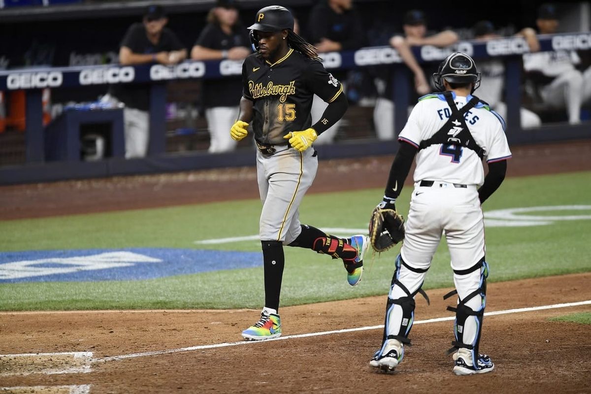 Mar 28, 2024; Miami, Florida, USA;  Pittsburgh Pirates shortstop Oneil Cruz (15) trots to home plate in front of Miami Marlins catcher Nick Fortes (4) during the eighth inning, at loanDepot Park.