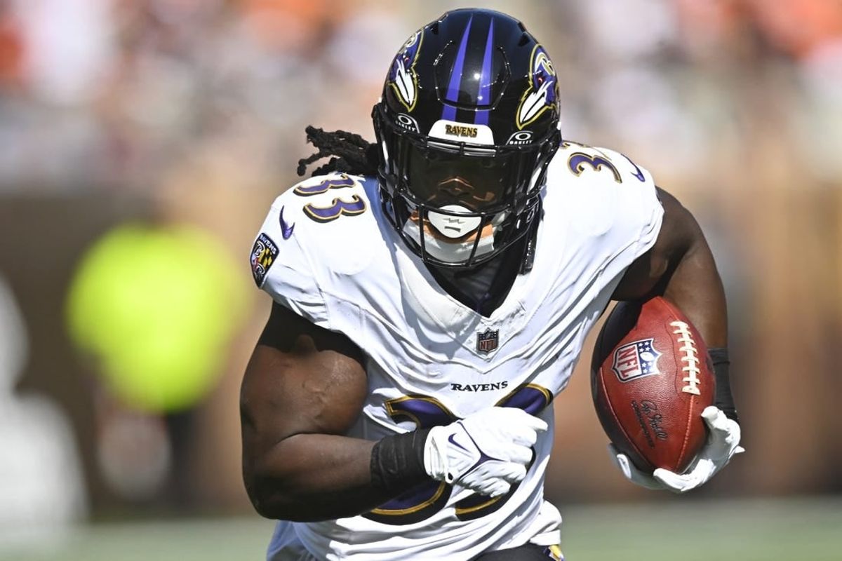 Oct 1, 2023; Cleveland, Ohio, USA; Baltimore Ravens running back Melvin Gordon III (33) runs with the ball in the second quarter against the Cleveland Browns at Cleveland Browns Stadium.