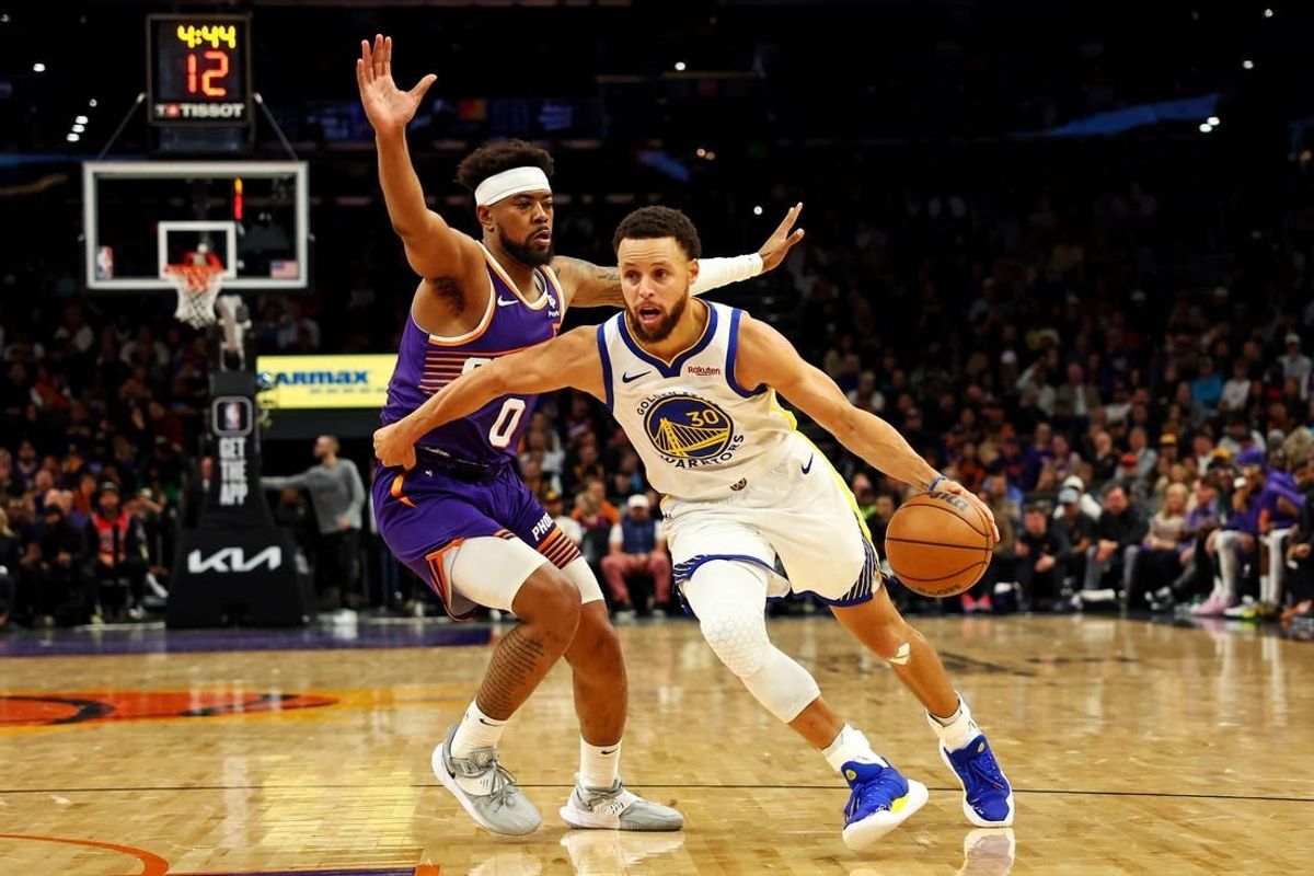 Dec 12, 2023; Phoenix, Arizona, USA; Golden State Warriors guard Stephen Curry (30) drives to the basket against Phoenix Suns guard Jordan Goodwin (0) during the third quarter at Footprint Center.