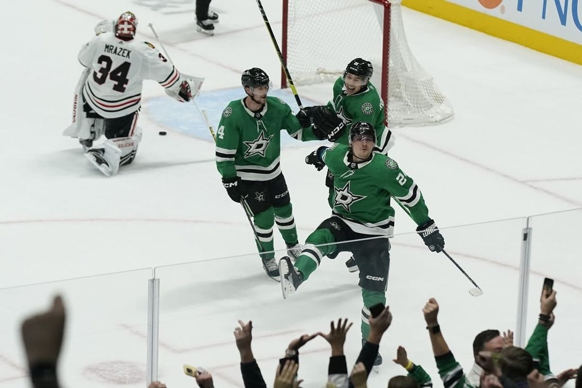 Dec 29, 2023; Dallas, Texas, USA; Dallas Stars center Roope Hintz (24) reacts with defenseman Miro Heiskanen (4) and left wing Jason Robertson (21) in front of Chicago Blackhawks goaltender Petr Mrazek (34) after scoring the game winning goal during overtime at American Airlines Center.
