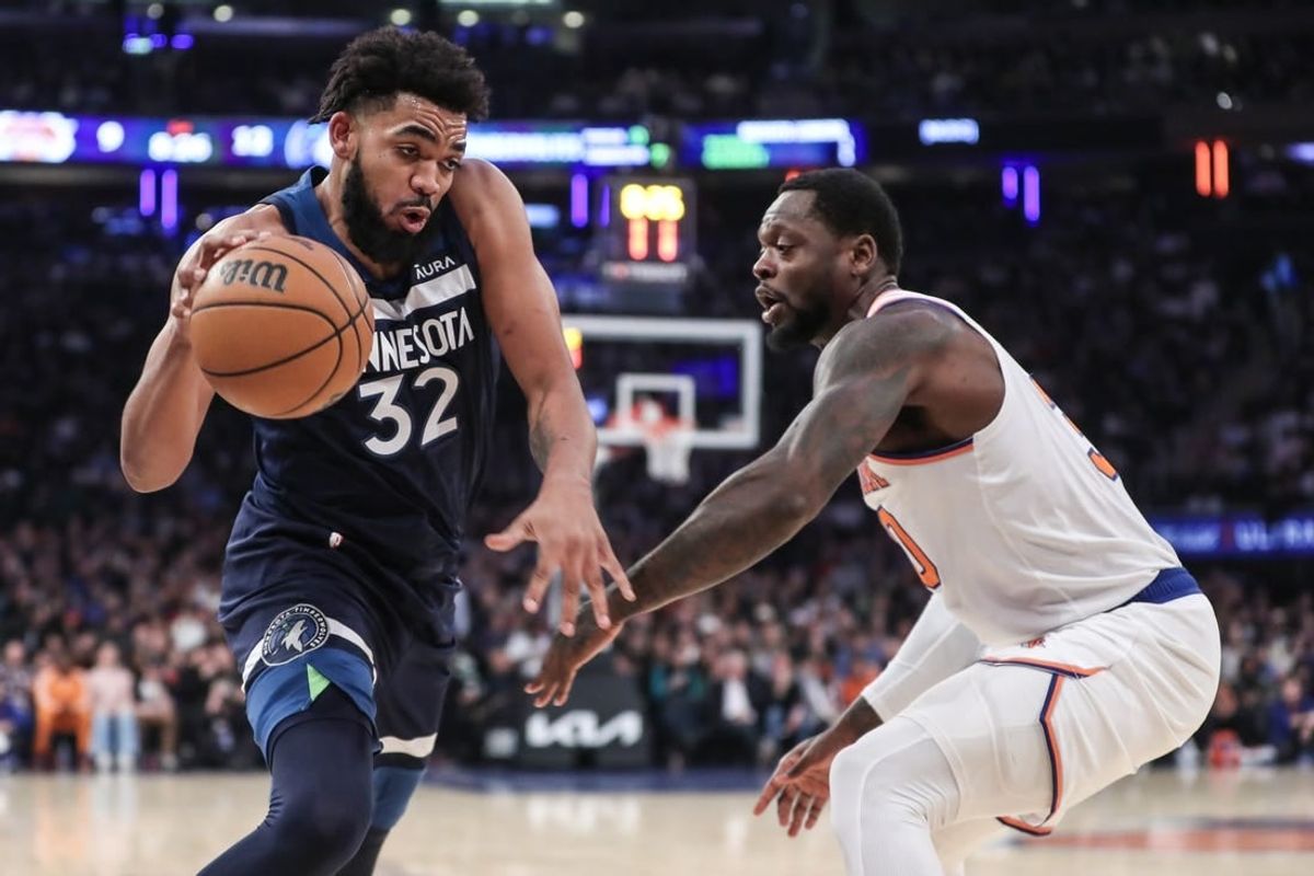 Jan 1, 2024; New York, New York, USA;  Minnesota Timberwolves center Karl-Anthony Towns (32) looks to drive past New York Knicks forward Julius Randle (30) in the first quarter at Madison Square Garden.