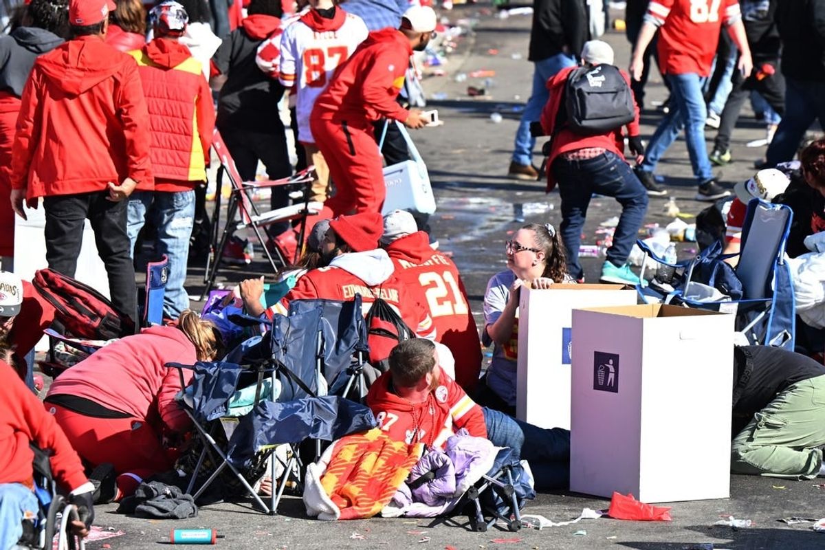 Feb 14, 2024; Kansas City, MO, USA; Fans shelter in place after shots were fired after the celebration of the Kansas City Chiefs winning Super Bowl LVIII.