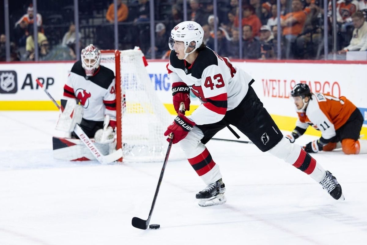 Nov 30, 2023; Philadelphia, Pennsylvania, USA; New Jersey Devils defenseman Luke Hughes (43) skates with the puck against the Philadelphia Flyers during the first period at Wells Fargo Center.