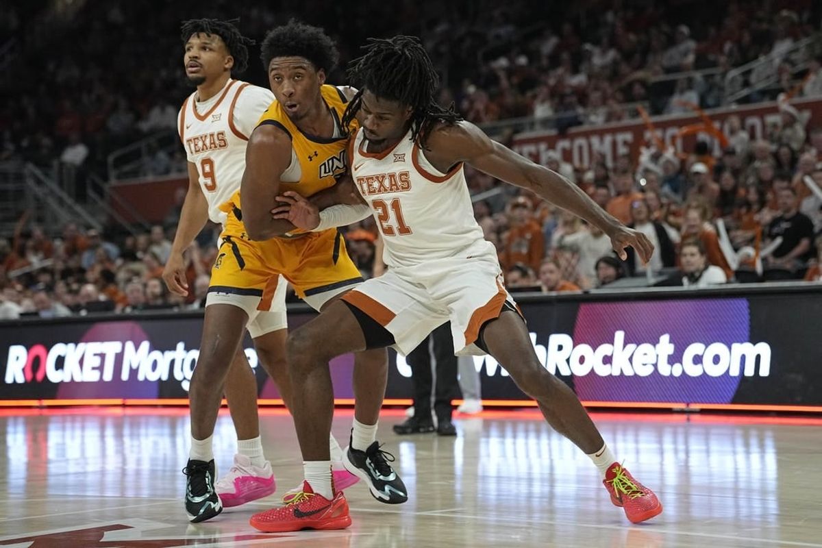 Dec 29, 2023; Austin, Texas, USA; Texas Longhorns forward Ze'Rik Onyema (21) boxes out UNC Greensboro Spartans forward Jalen Breath (22) during the second half at Moody Center.