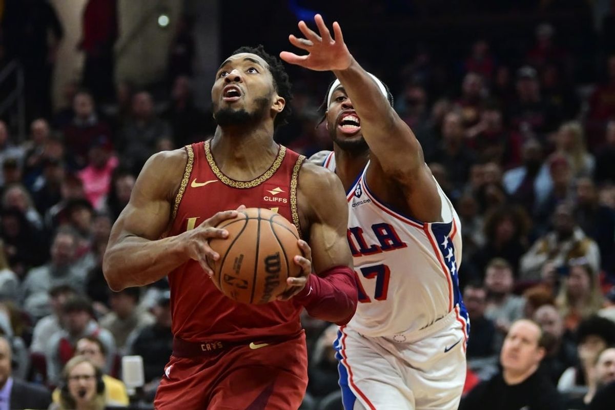 Feb 12, 2024; Cleveland, Ohio, USA; Cleveland Cavaliers guard Donovan Mitchell (45) drives to the basket against Philadelphia 76ers guard Buddy Hield (17) during the second half at Rocket Mortgage FieldHouse.