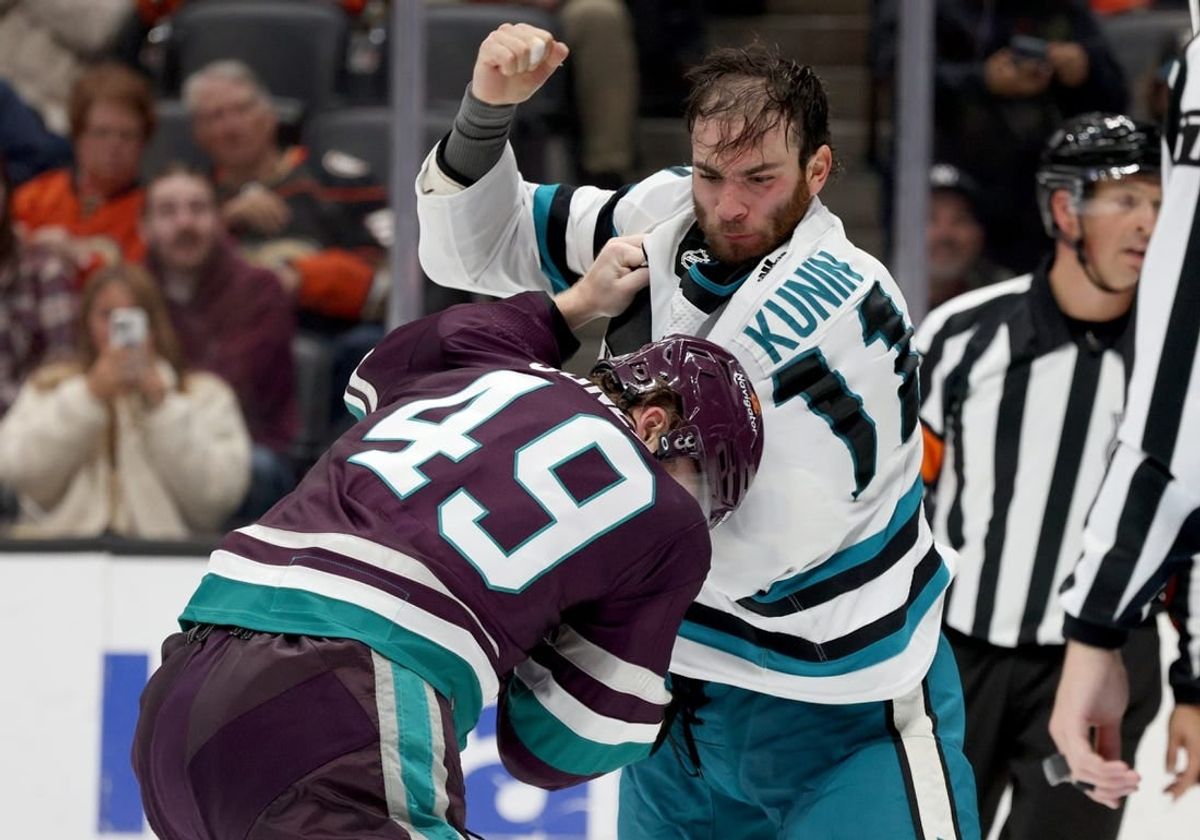 Nov 12, 2023; Anaheim, California, USA; San Jose Sharks center Luke Kunin (11) and Anaheim Ducks left wing Max Jones (49) fight during the second period at Honda Center.