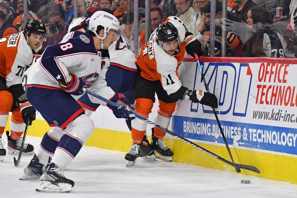 Nov 19, 2023; Philadelphia, Pennsylvania, USA; Columbus Blue Jackets defenseman Zach Werenski (8) and Philadelphia Flyers right wing Travis Konecny (11) battle for the puck during the first period at Wells Fargo Center.