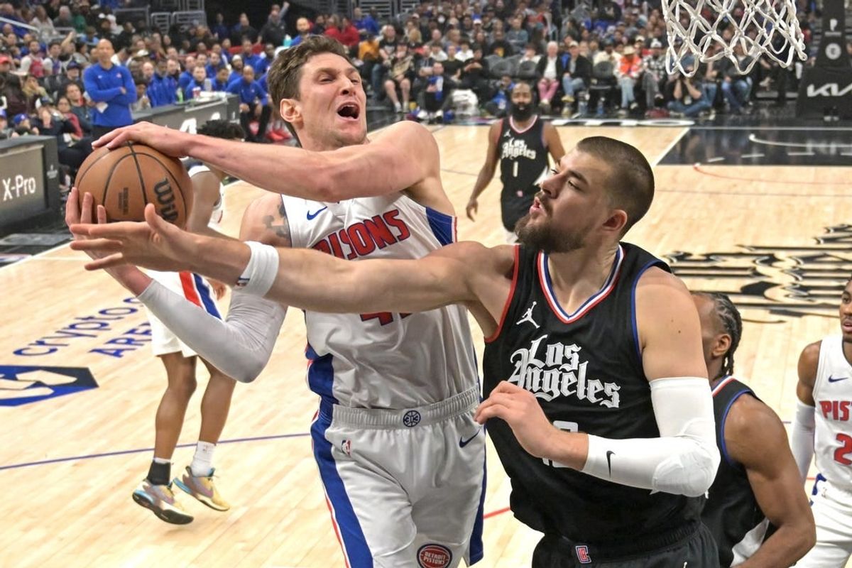 Feb 10, 2024; Los Angeles, California, USA;  Detroit Pistons center Mike Muscala (41) reaches in front of Los Angeles Clippers center Ivica Zubac (40) for a rebound in the first half at Crypto.com Arena.