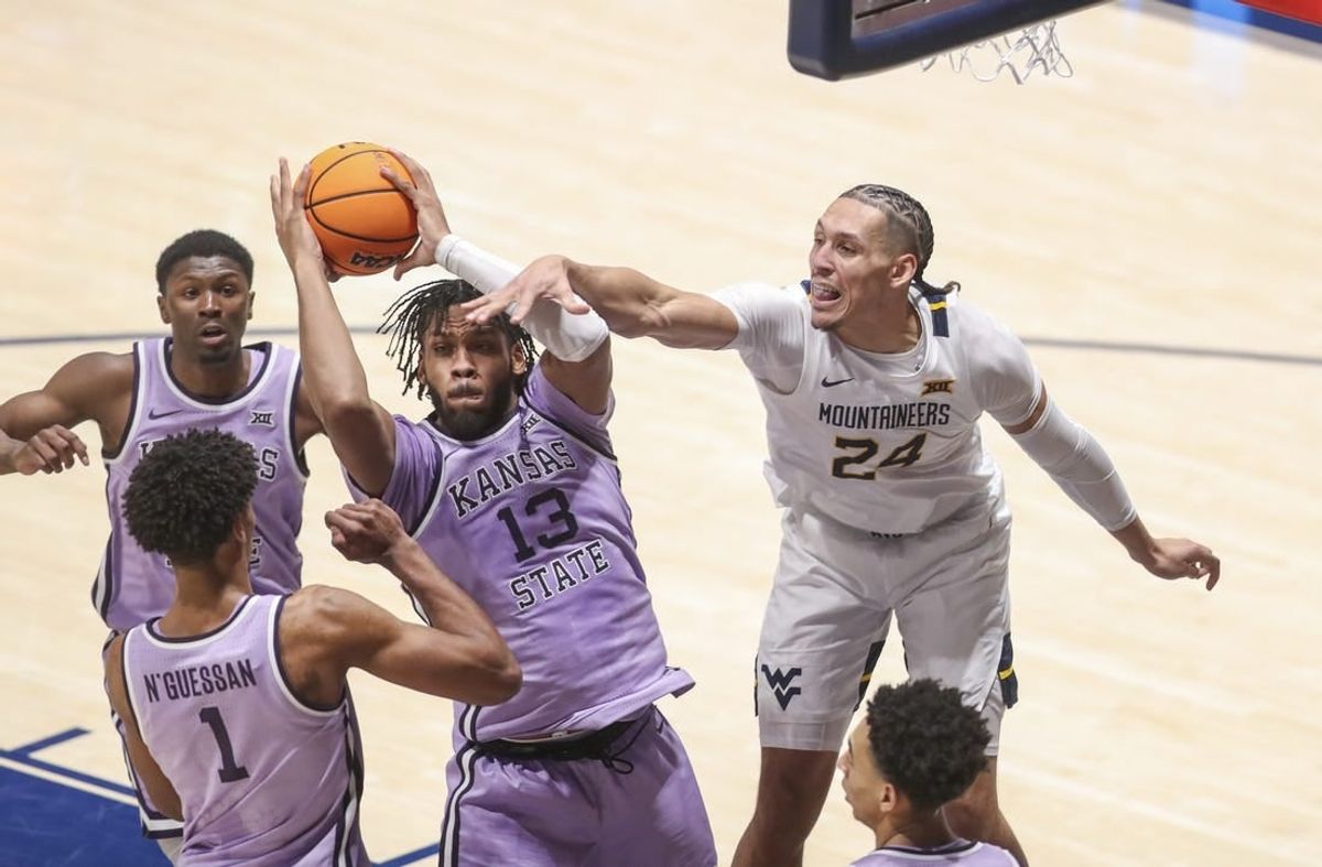 Jan 9, 2024; Morgantown, West Virginia, USA; Kansas State Wildcats forward Will McNair Jr. (13) grabs a rebound over West Virginia Mountaineers forward Patrick Suemnick (24) during the first half at WVU Coliseum.