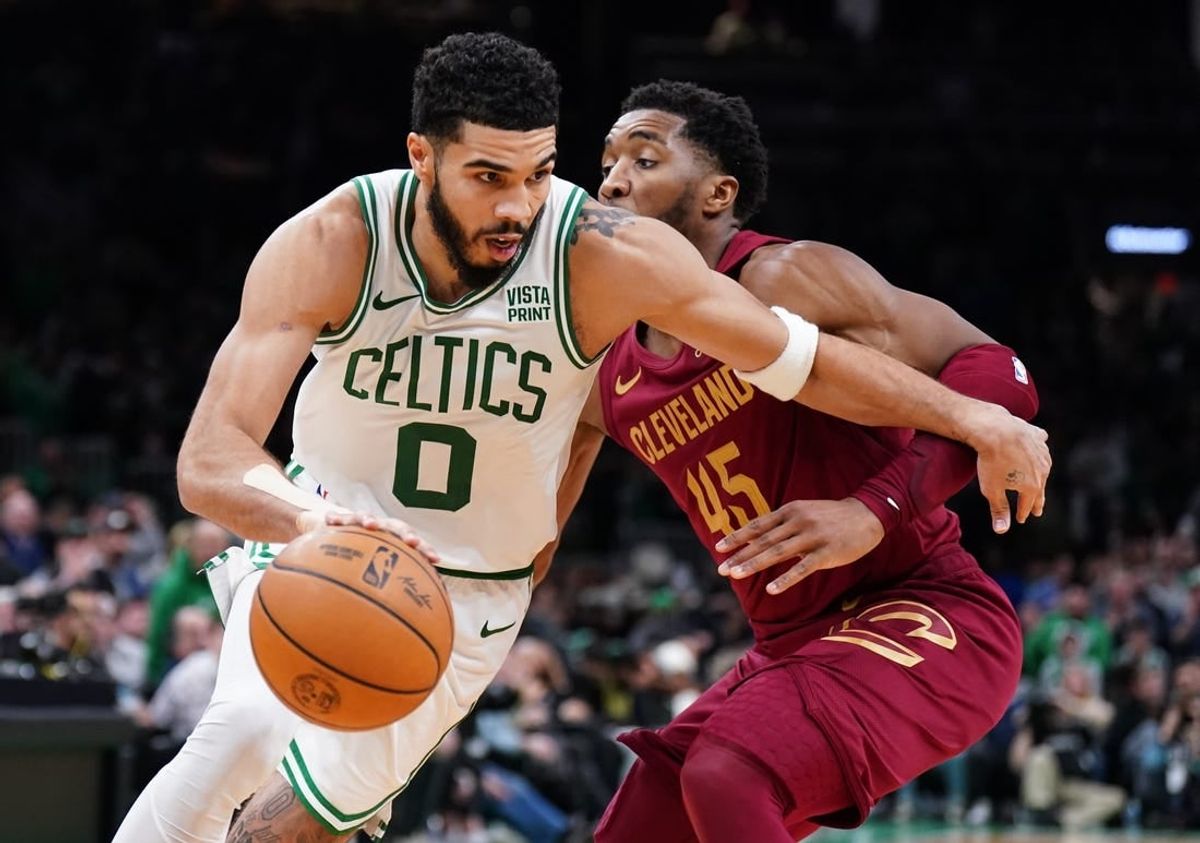Dec 12, 2023; Boston, Massachusetts, USA; Boston Celtics forward Jayson Tatum (0) drives the ball against Cleveland Cavaliers guard Donovan Mitchell (45) in the second half at TD Garden.