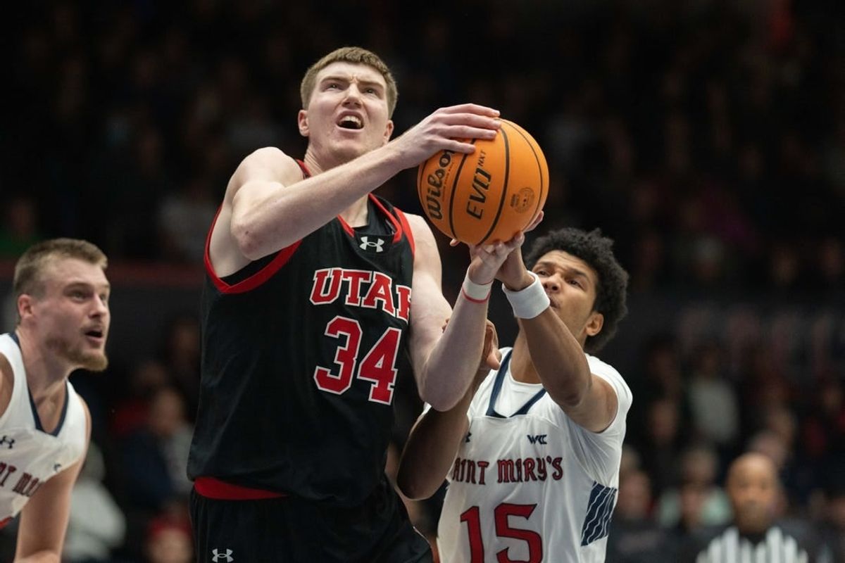 Nov 27, 2023; Moraga, California, USA;  Utah Utes center Lawson Lovering (34) attempts to shoot the ball during the first half against St. Mary's Gaels guard Chris Howell (15) at University Credit Union Pavilion.