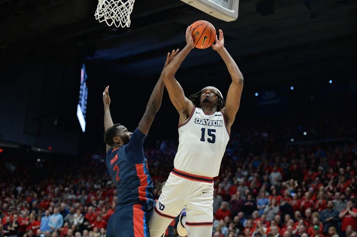 Feb 13, 2024; Dayton, Ohio, USA;  Dayton Flyers forward DaRon Holmes II (15) shoots the ball against Duquesne forward David Dixon (2) during the game at University of Dayton Arena.