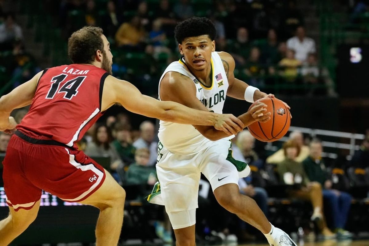 Nov 12, 2023; Waco, Texas, USA;  Baylor Bears guard RayJ Dennis (10) controls the ball against Gardner Webb Runnin Bulldogs guard Shahar Lazar (14) during the first half at Ferrell Center.