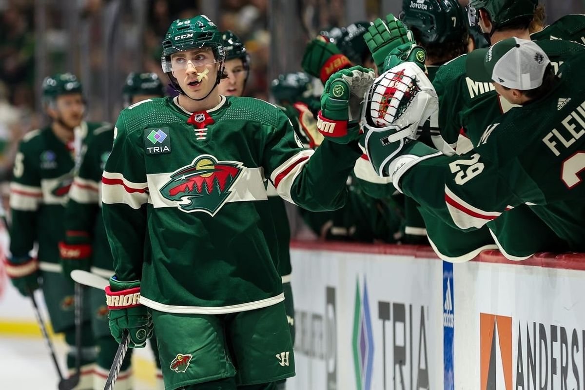 Feb 27, 2024; Saint Paul, Minnesota, USA; Minnesota Wild center Connor Dewar (26) celebrates his goal against the Carolina Hurricanes during the first period at Xcel Energy Center.