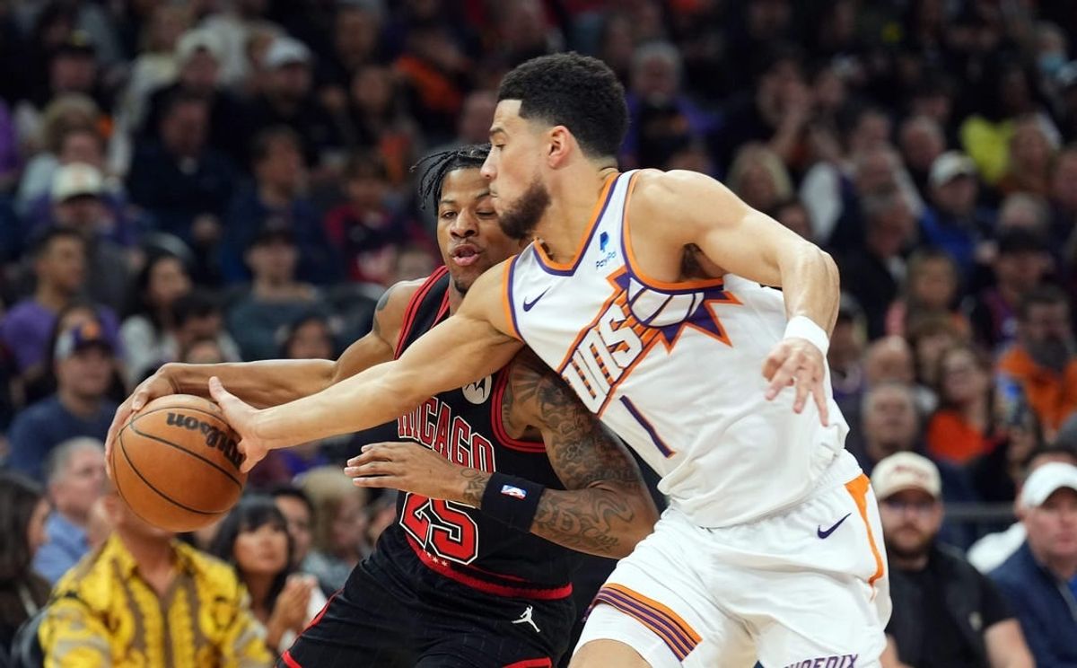 Jan 22, 2024; Phoenix, Arizona, USA; Phoenix Suns guard Devin Booker (1) guards Chicago Bulls forward Dalen Terry (25) during the first half at Footprint Center.