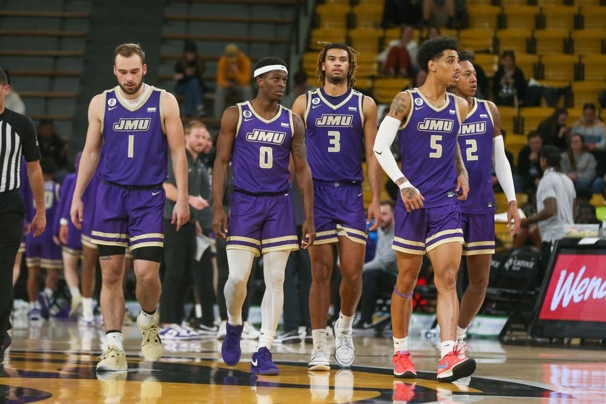 Jan 6, 2024; Hattiesburg, Mississippi, USA; James Madison Dukes players Noah Freidel (1), Xavier Brown (0), T.J. Bickerstaff (3), Terrence Edwards Jr. (5), and Raekwon Horton (2) after a timeout during the second half of their game against the Southern Miss Golden Eagles at Reed Green Coliseum.