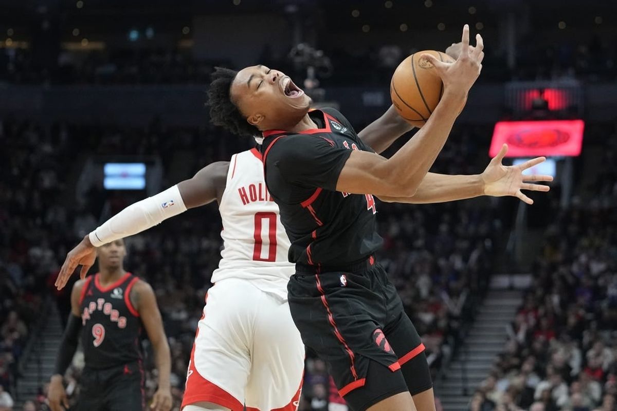 Feb 9, 2024; Toronto, Ontario, CAN; Toronto Raptors forward Scottie Barnes (4) pulls in a pass against Houston Rockets guard Aaron Holiday (0) during the first half at Scotiabank Arena.