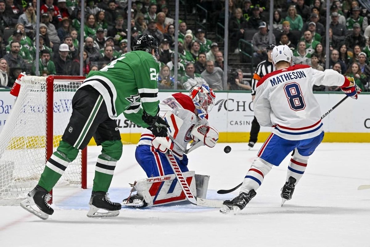Jan 2, 2024; Dallas, Texas, USA; Dallas Stars center Roope Hintz (24) attempts to put the puck past Montreal Canadiens goaltender Sam Montembeault (35) and defenseman Mike Matheson (8) during the second period at the American Airlines Center.