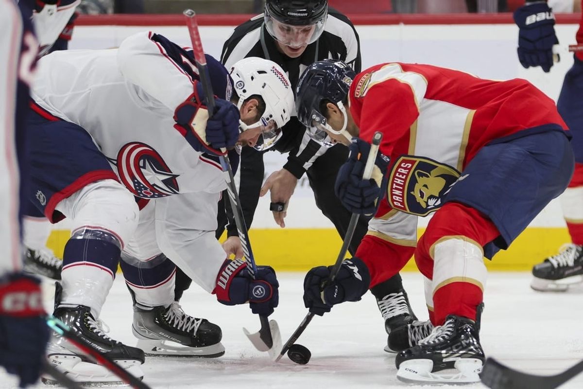Nov 6, 2023; Sunrise, Florida, USA; Columbus Blue Jackets center Sean Kuraly (7) and Florida Panthers right wing William Lockwood (67) face-off during the second period at Amerant Bank Arena.
