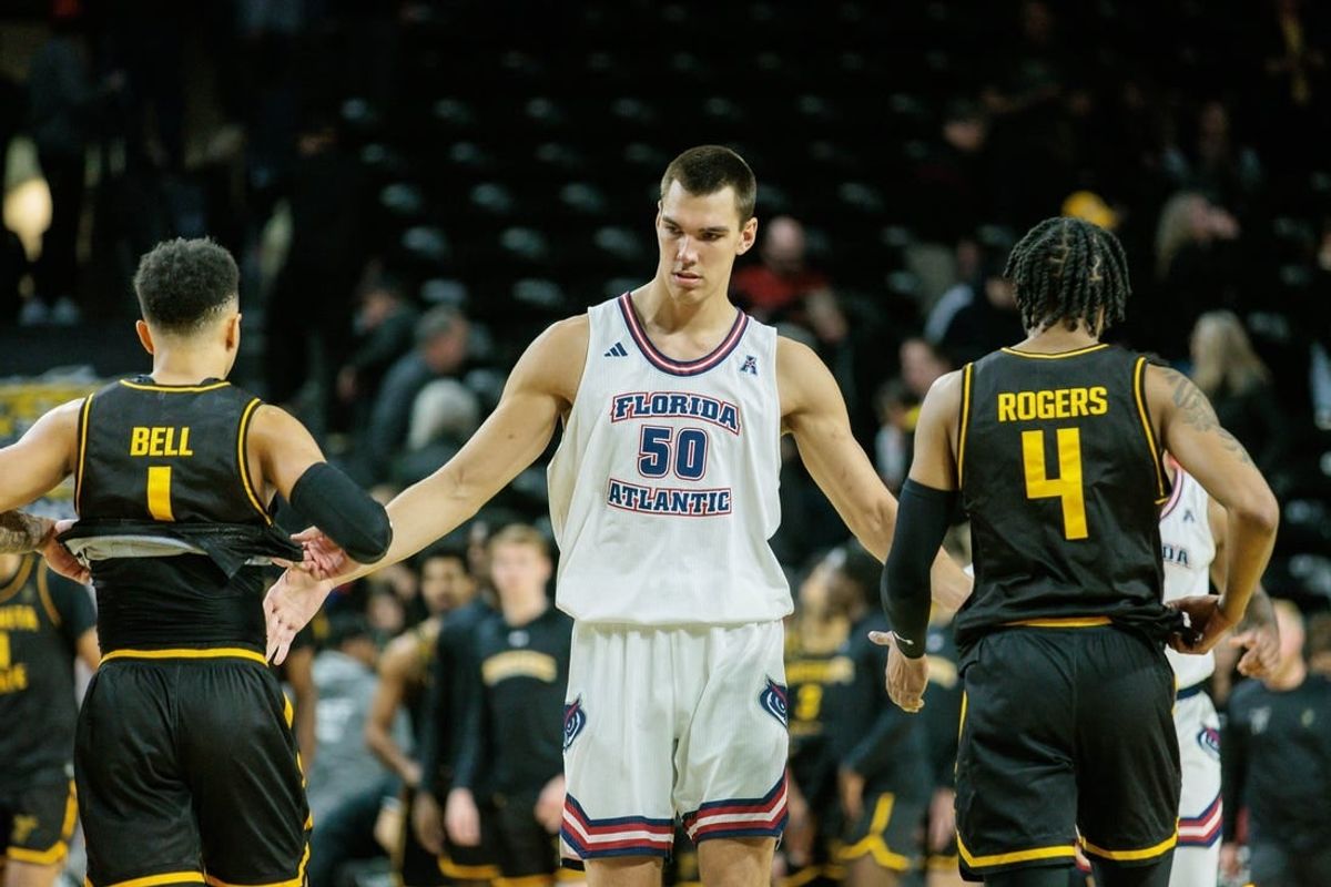 Feb 11, 2024; Wichita, Kansas, USA; Florida Atlantic Owls center Vladislav Goldin (50) slaps hands with Wichita State Shockers guard Xavier Bell (1) and Wichita State Shockers guard Colby Rogers (4) after the game at Charles Koch Arena.