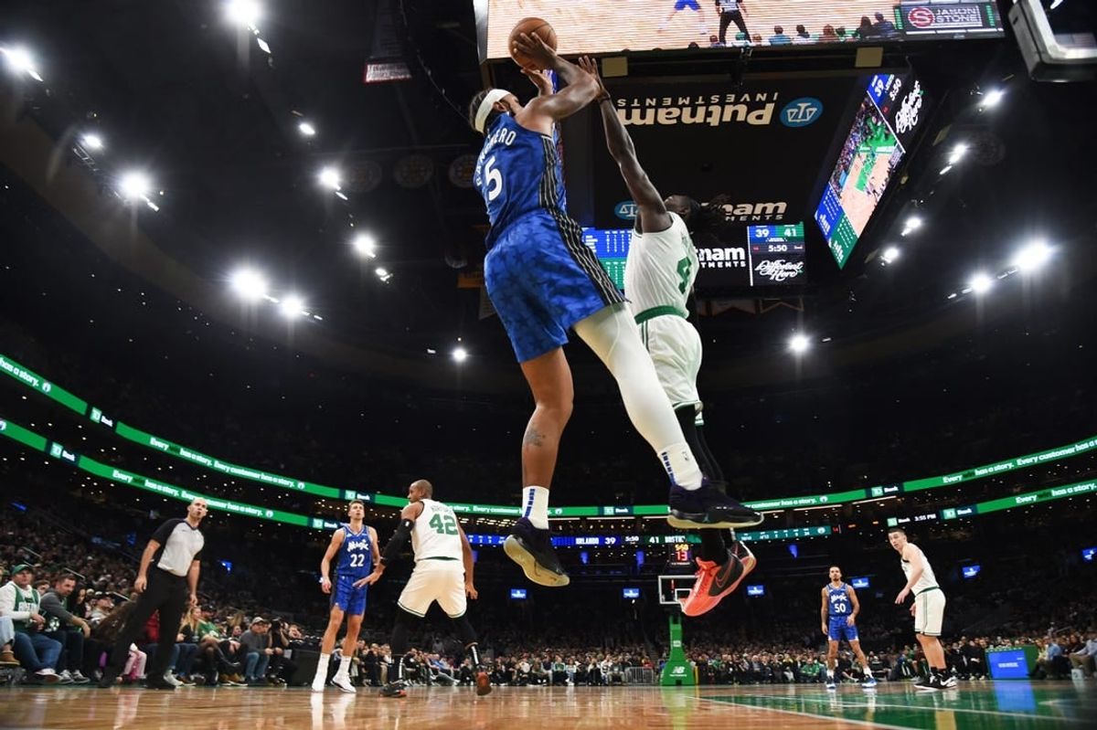 Dec 17, 2023; Boston, Massachusetts, USA;  Orlando Magic forward Paolo Banchero (5) shoots the ball over Boston Celtics guard Jrue Holiday (4) during the first half at TD Garden.