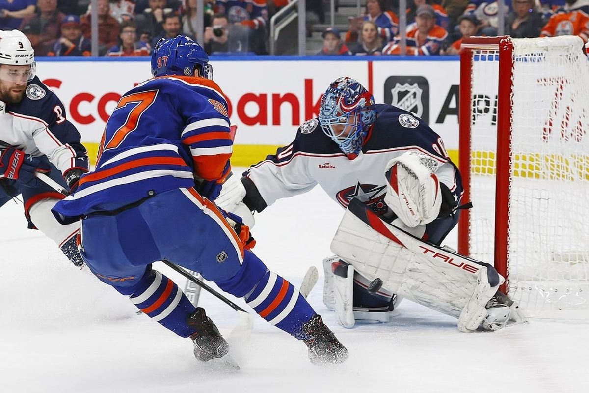 Jan 23, 2024; Edmonton, Alberta, CAN; Columbus Blue Jackets goaltender Elvis Merzlikins (90) makes a save on  on Edmonton Oilers forward Connor McDavid (97) during the first period at Rogers Place.