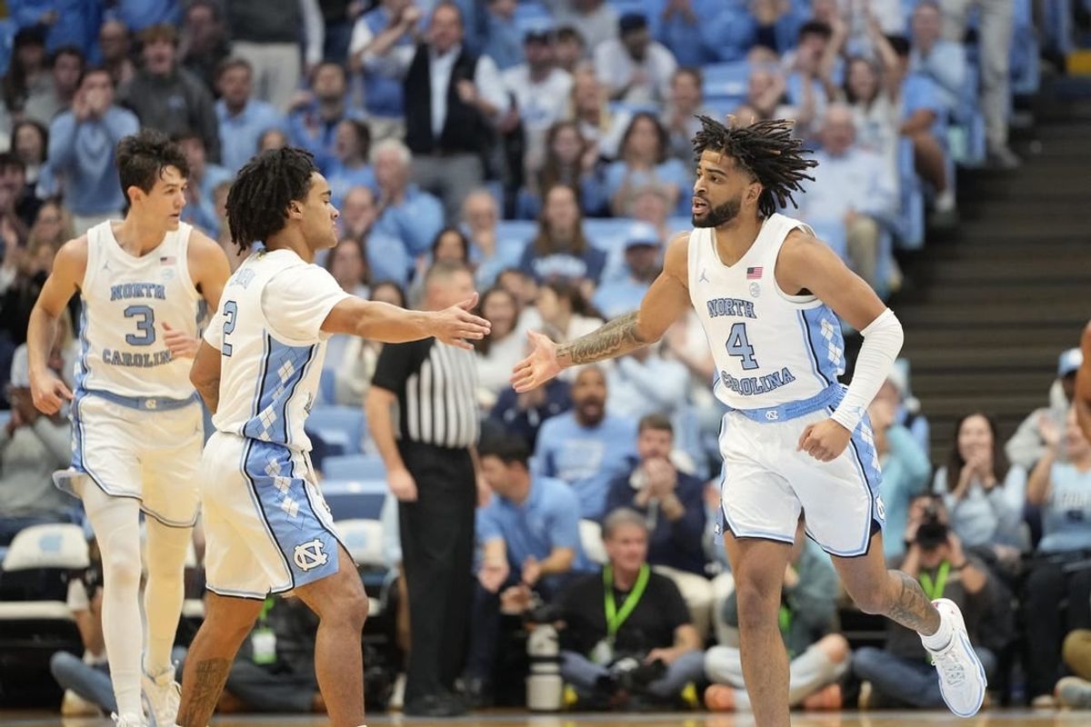 Dec 2, 2023; Chapel Hill, North Carolina, USA;  North Carolina Tar Heels guard Elliot Cadeau (2) reacts with guard RJ Davis (4) in the first half at Dean E. Smith Center.