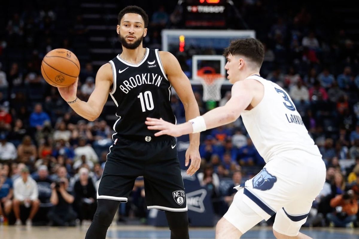 Feb 26, 2024; Memphis, Tennessee, USA; Brooklyn Nets guard Ben Simmons (10) passes the ball as Memphis Grizzlies forward Jake LaRavia (3) defends during the second half at FedExForum.