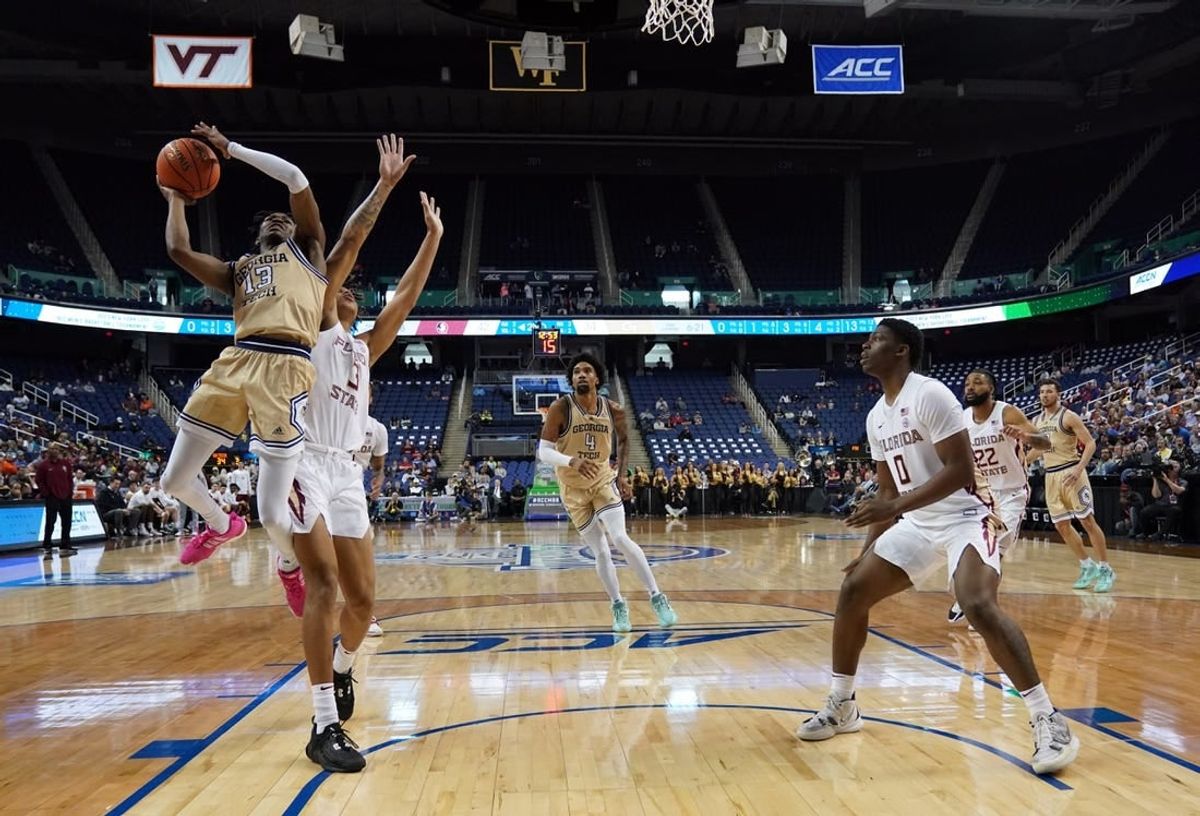 Mar 7, 2023; Greensboro, NC, USA; Georgia Tech Yellow Jackets guard Miles Kelly (13) goes up for a shot against Florida State Seminoles forward Cam Corhen (3) during the second half of the first round of the ACC tournament at Greensboro Coliseum.