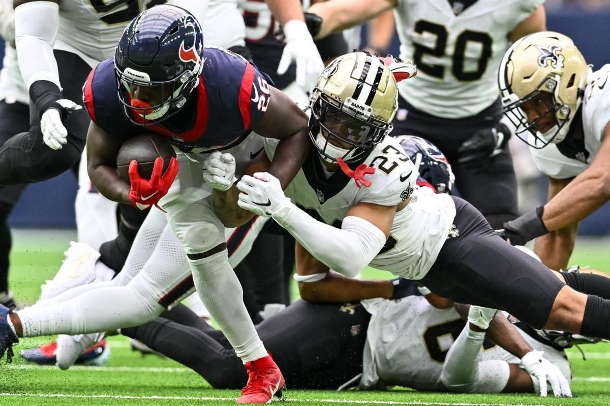 Oct 15, 2023; Houston, Texas, USA; New Orleans Saints cornerback Marshon Lattimore (23) tackles Houston Texans running back Devin Singletary (26) during the second quarter at NRG Stadium.