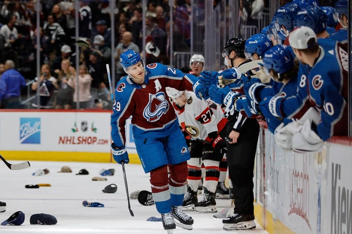 Dec 21, 2023; Denver, Colorado, USA; Colorado Avalanche center Nathan MacKinnon (29) celebrates his hat trick goal with the bench in the third period against the Ottawa Senators at Ball Arena.